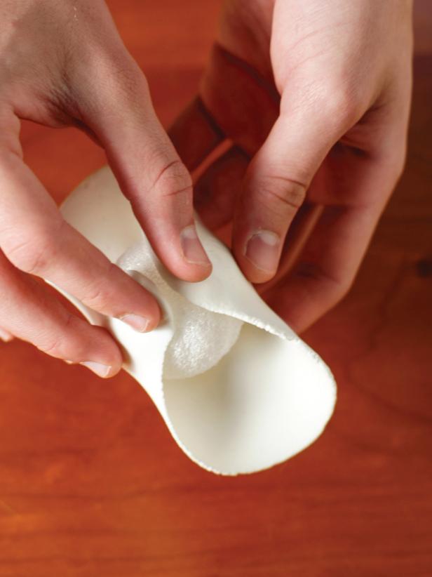 Using a rolling pin, roll out the foam to about 1/4-inch thickness. Wrap the foam circle around the ball and pinch it together to completely cover the ball. Pinch away any excess.