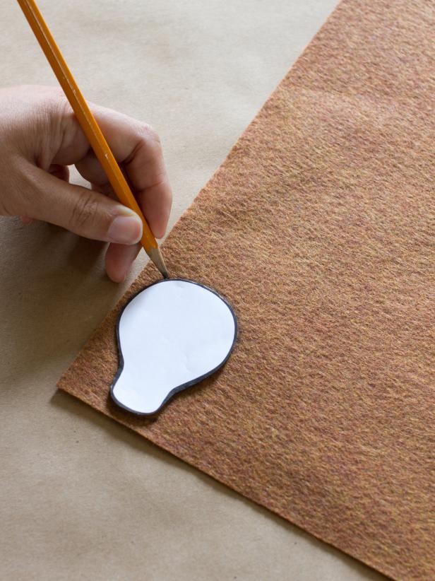 Create two reindeer heads by tracing the template shape twice onto a piece of brown felt.