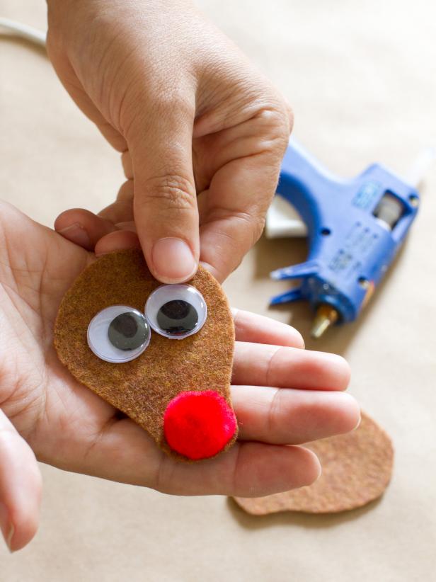 Then attach two googly eyes to the face, above the pom-pom nose.
