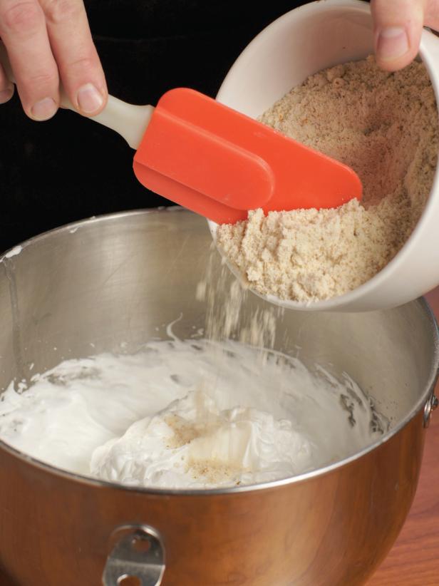 5. Turn mixer to high speed and very gradually sprinkle in the 1/3 cup superfine sugar. Whip on high speed until very stiff peaks form.6. Gently fold in ground almonds (Images 1 and 2).