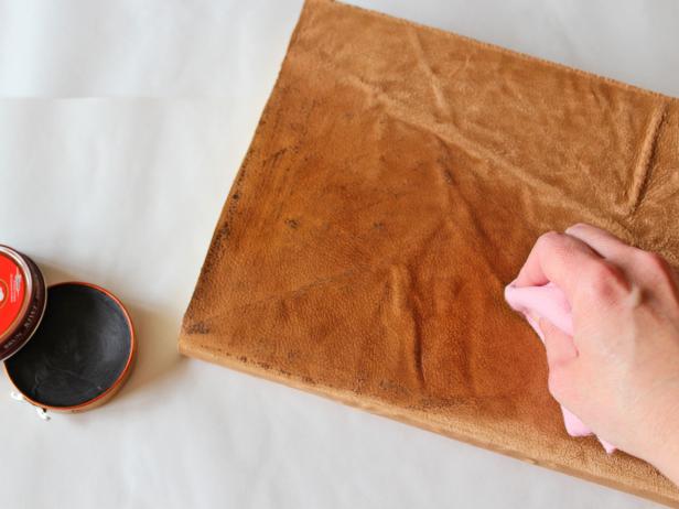 Using a soft cotton cloth, apply shoe polish in a darker shade really working it into the leather and concentrating on the areas you distressed.