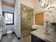 Warm grays and spa-like touches give this guest bathroom a clean, relaxing vibe.