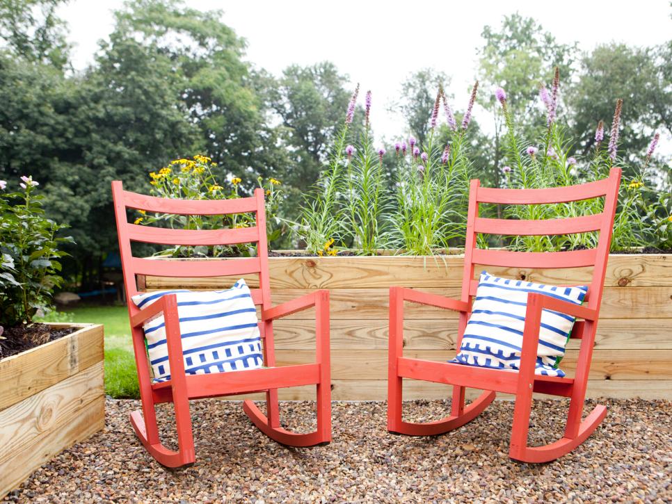 Transitional Outdoor Living Space With Red Rocking Chairs