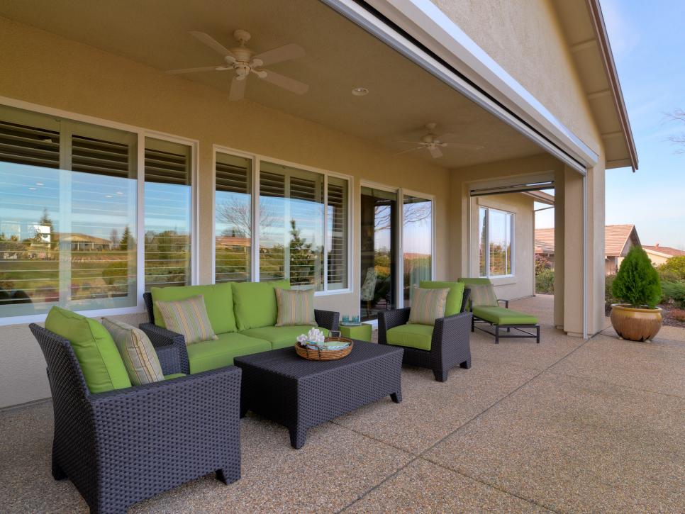 Contemporary Patio With Sun Shades and Wicker Furniture