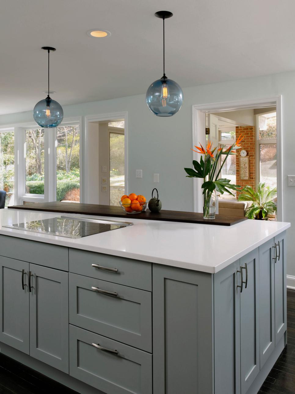 Family-Friendly Island With Blue Cabinetry and Globe Pendant Lighting