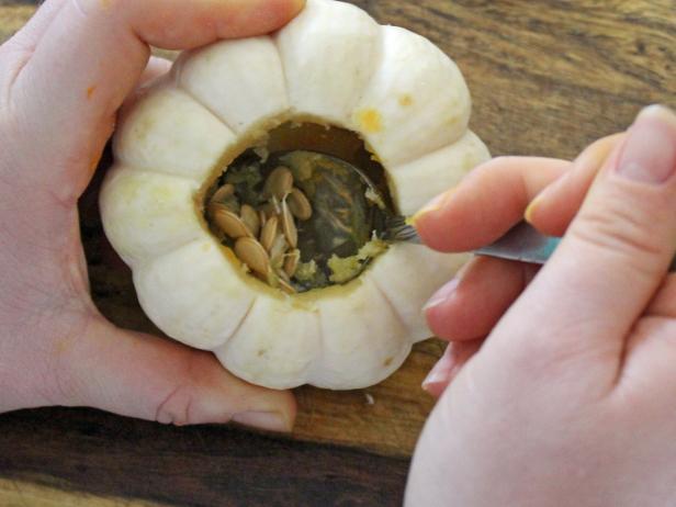 For step three of the project, scoop out the remaining seeds and flesh with a tea spoon. Discard top and seeds.
