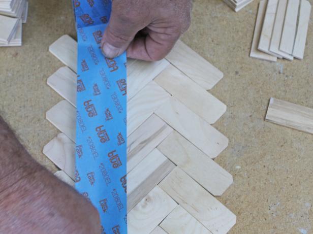 Once you're happy with the first section of runner, run two strips of painter's tape across both sides of the runner. Flip over.