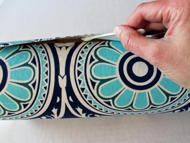 Continue wrapping and gluing fabric around tube until you reach the end. The interfacing prevents the cut fabric from fraying so there's no need to turn fabric under to create a clean edge — just overlap where the fabric meets and glue down the end.