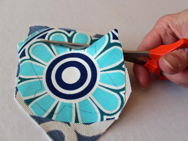 Use sharp scissors to cut along traced pencil lines from the printed out template to create a unique shape.