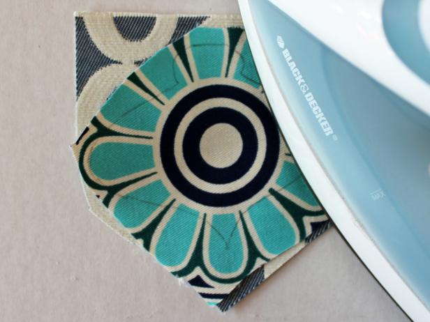 Once fabric has cooled, then peel off the paper backing — your fabric now has an adhesive side and can be applied to another piece of fabric. Place fabric glue-side-down onto the back side of coordinating fabric then fuse the two layers together by pressing again with the iron.