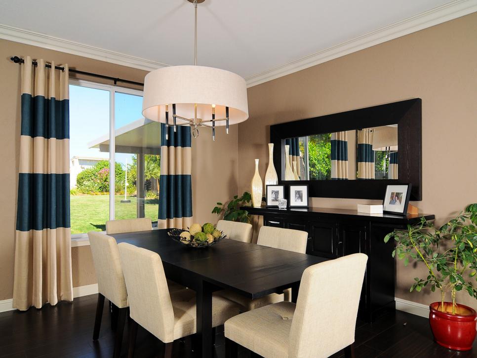 Neutral Dining Space With Striped Curtains and Contemporary Chandelier