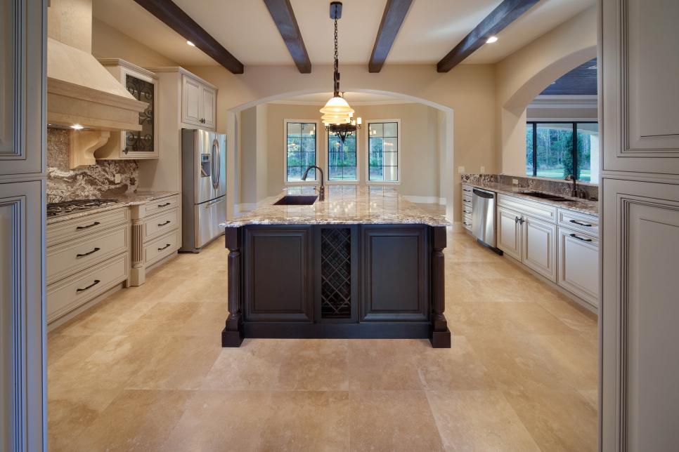 Old World Kitchen with Black Island and Exposed Beams
