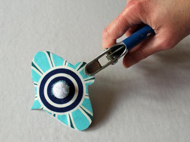 Use a hole punch or nail to create a small hole in the ornament's top then thread through ribbon for hanging on a christmas tree or attaching to a gift.