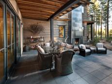 Designed to take advantage of the forest and mountain views, this outdoor kitchen and dining space provides a  stylish spot to enjoy the natural beauty of Tahoe.