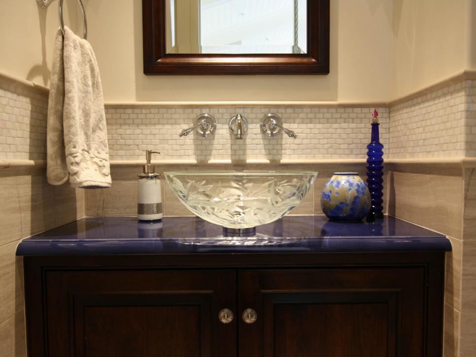 Bathroom With Deep Blue Countertop and Glass Vessel Sink
