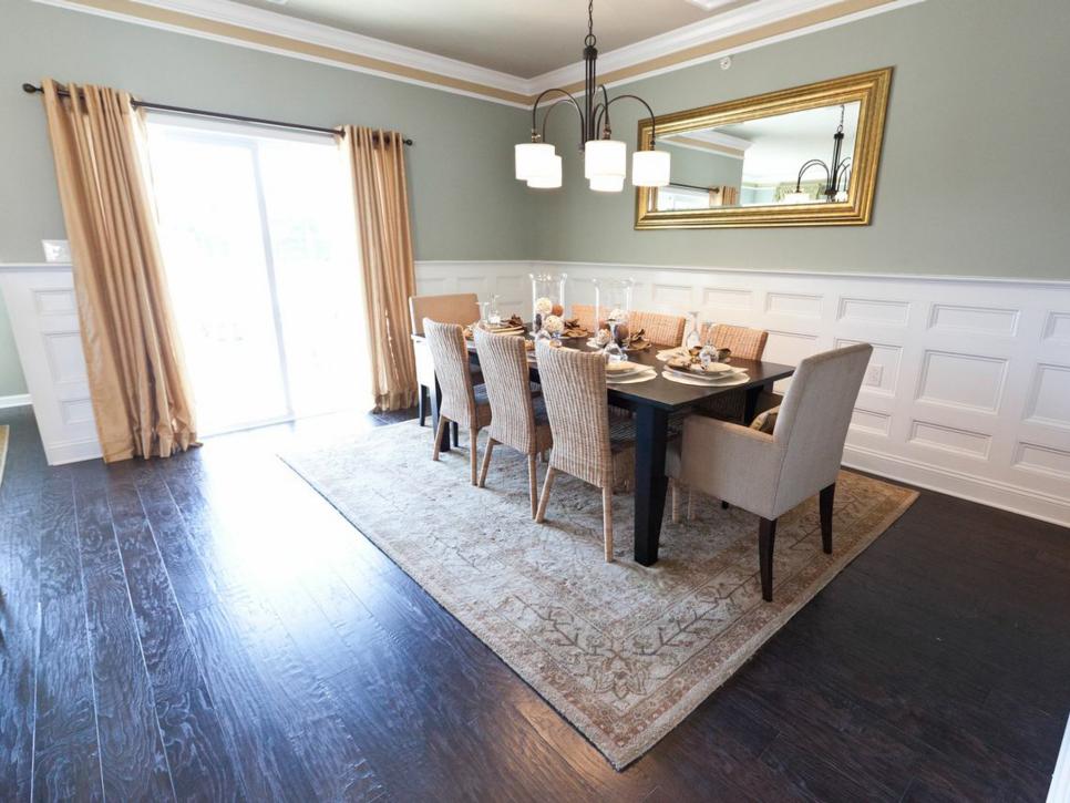 Contemporary Green Dining Room With White Wainscoting and Dark Hardwood Floors