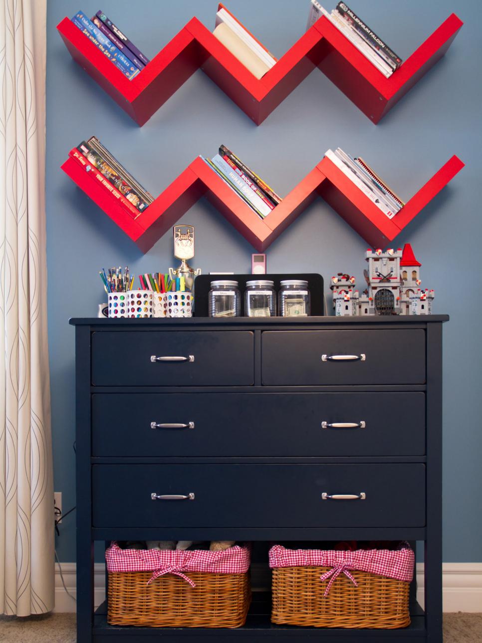 Floating Chevron-Shaped Red Shelves and Blue Dresser with Wicker Baskets