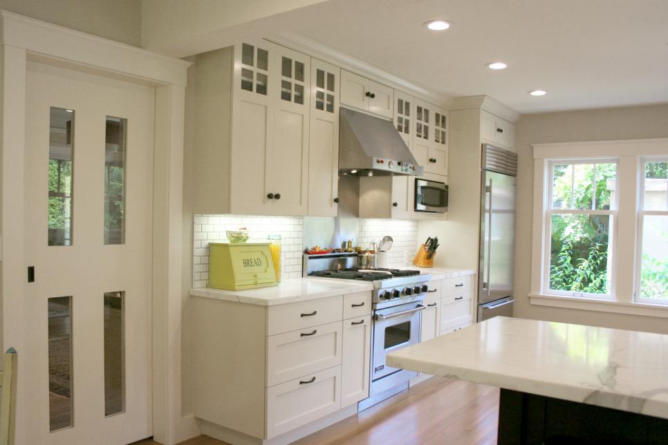 White Transitional Kitchen With Craftsman Cabinetry and White Sliding Door