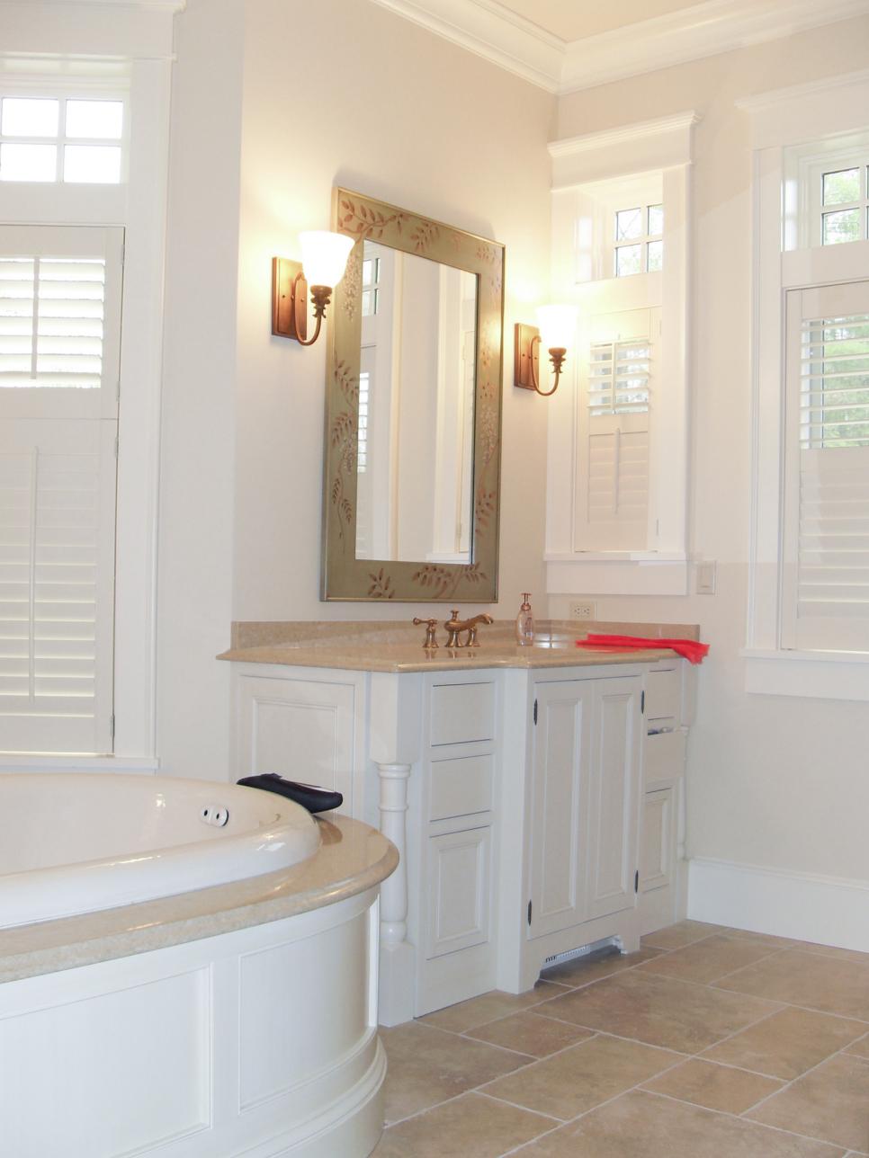 White Master Bathroom With White Vanity and Mirror