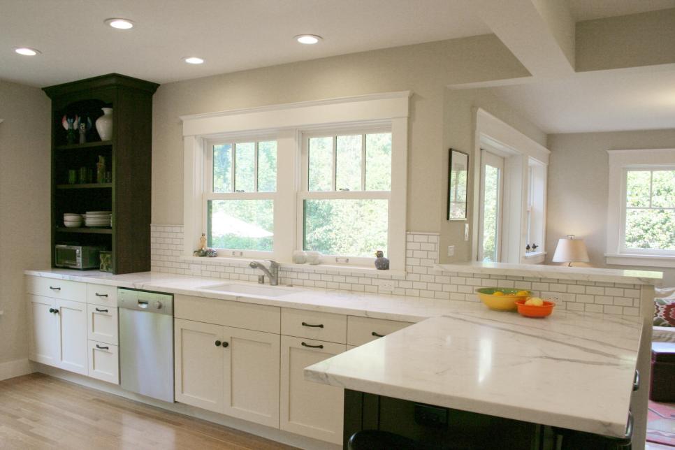 Transitional White Kitchen With White Cabinets and Dark-Stained Peninsula