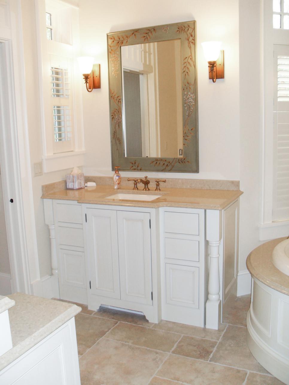 White Bathroom Vanity With Bronze Faucet and Painted Mirror