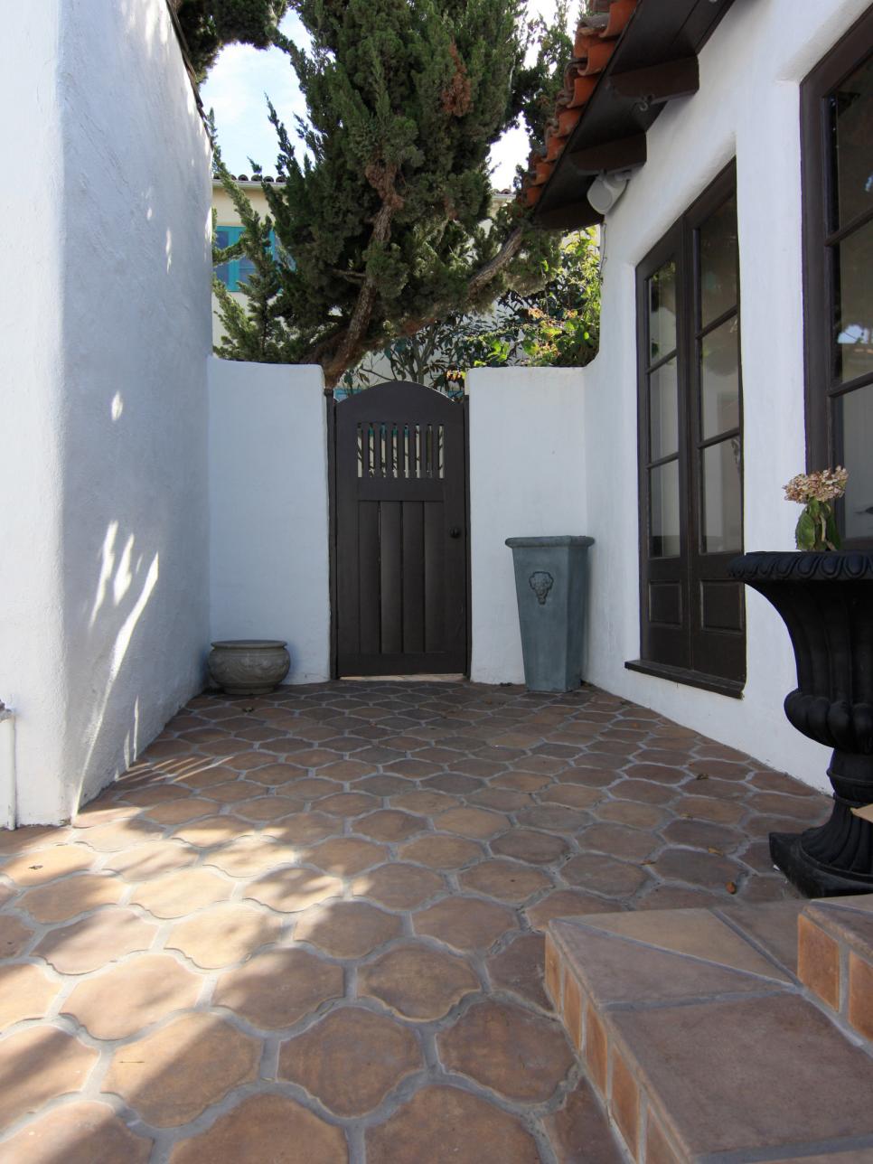 Courtyard With White Home Exterior, Red Roof and Terra-Cotta Pavers