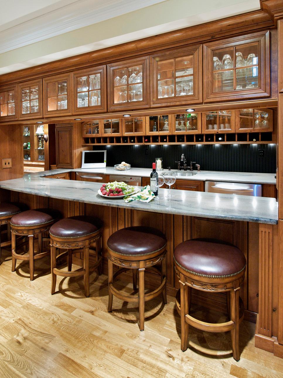 Traditional Bar With Glass-Front Cabinets and Custom Barstools 