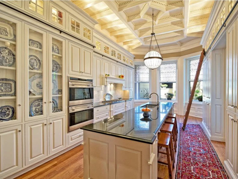 Traditional Kitchen With White Cabinetry and Island Seating