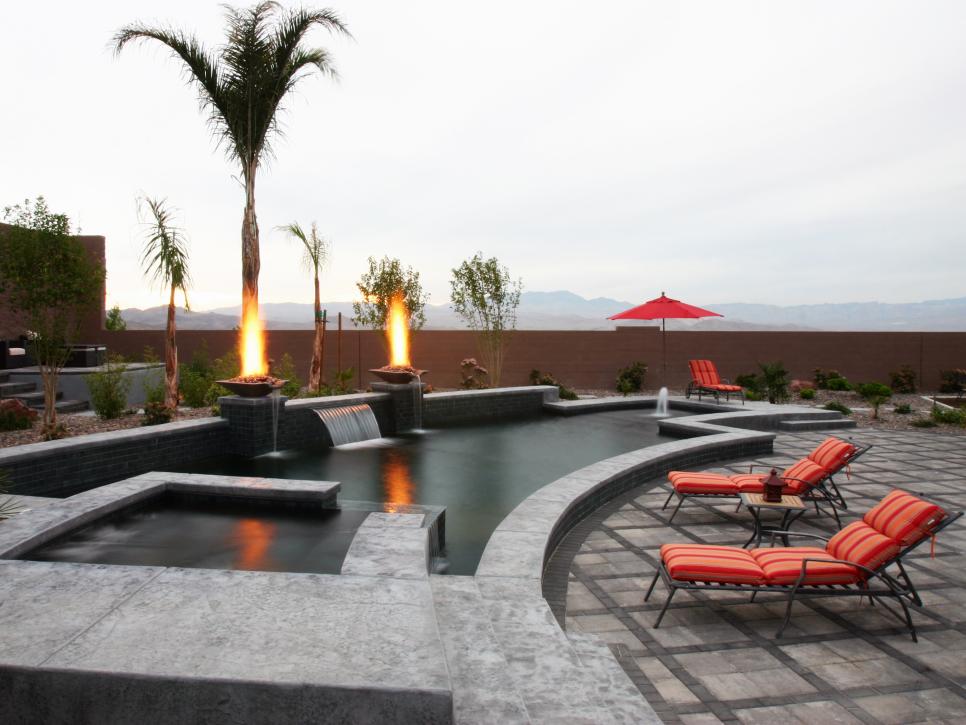 Modern Gray Stone Pool With Waterfall and Fire Pits