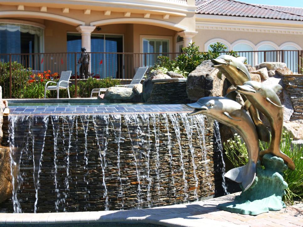 Outdoor Pool Waterfall and Dolphin Sculpture
