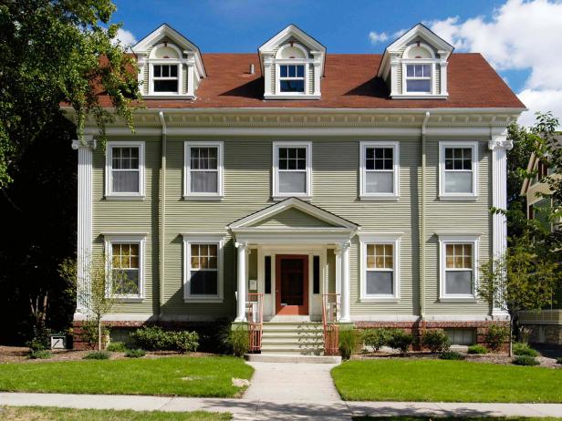 Tan Colonial Home With Three Dormers and Red Roof