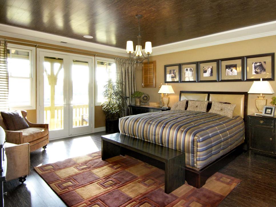 Transitional Master Bedroom with Hardwood Flooring and Ceiling Master bedroom with gold walls and dark wood on the floor and ceiling.