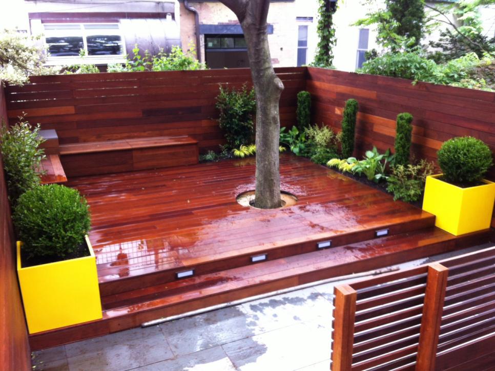 Fenced-In Red Deck with Bench and Yellow Planter