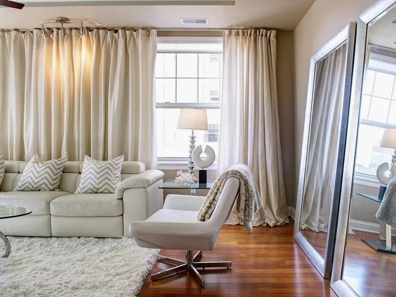 Transitional Beige Living Room With Patterned Accents and Floor-Length Curtains