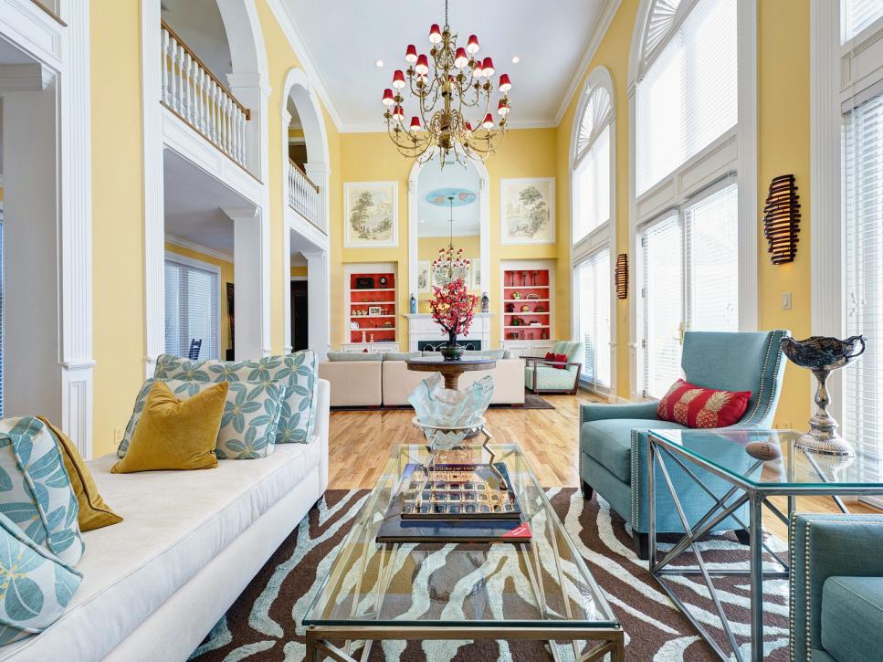 Yellow Two-Story Living Room With Chandelier and Zebra-Print Rug