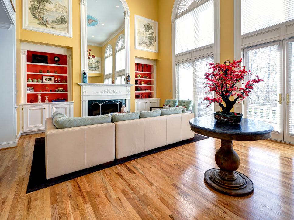 Yellow Living Room With Red and White Built-In Bookshelves