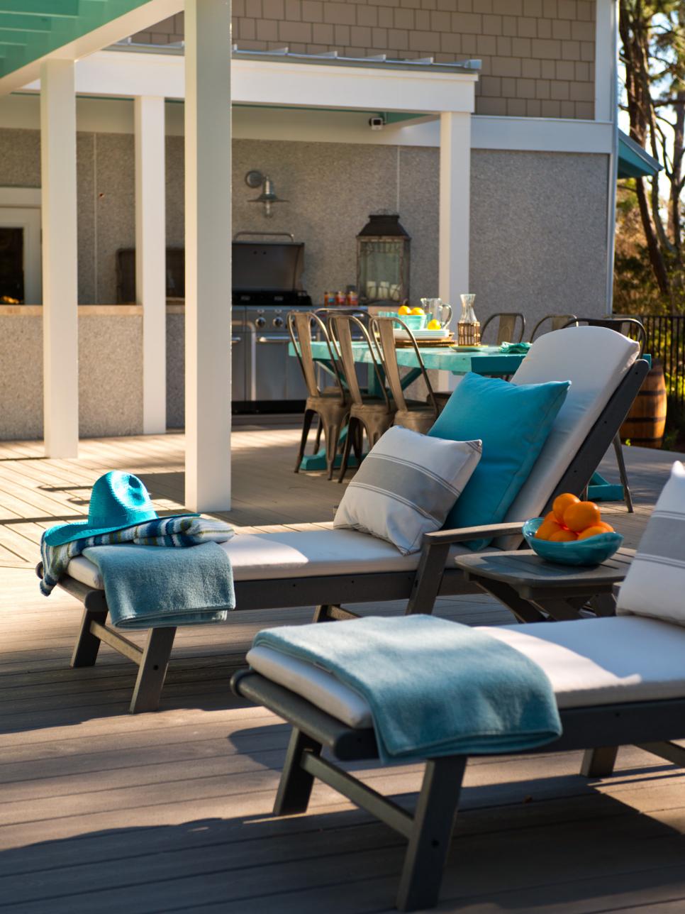Sun Deck With Eco-Friendly Outdoor Chaise Loungers Neutral Outdoor Chaises With Gray Frames and Blue Pillows
