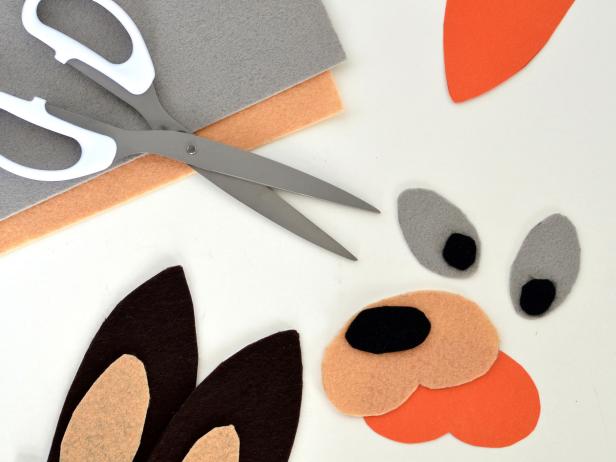 Step 1. Print Mama Kangaroo template and cut out stencils. Trace individual stencil shapes onto corresponding colored felt sheets and cut out. Repeat with Baby Kangaroo template