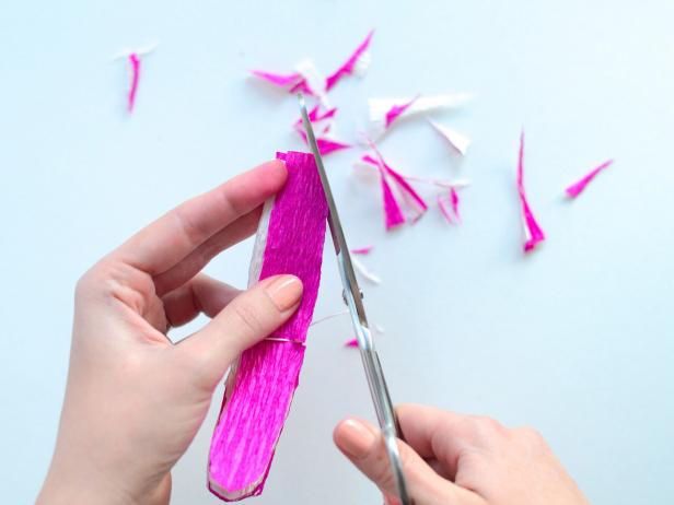 Next, use scissors to round folded paper's edges.