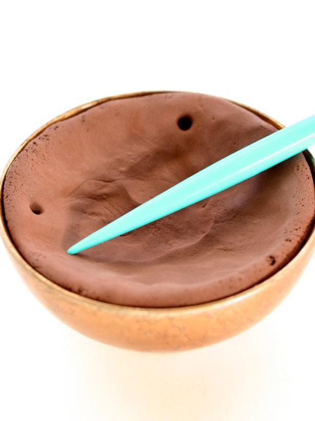 For each mold, use sharp pick to poke 2 1/4" holes through the clay at 12 o'clock and 9 o'clock. Allow to dry overnight or until clay has fully hardened.