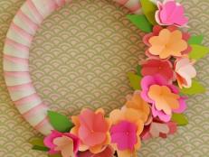 Use simple materials, like colorful card stock, quilting pins and ribbon, to create a one-of-a-kind floral wreath that's perfect for welcoming spring to your home.