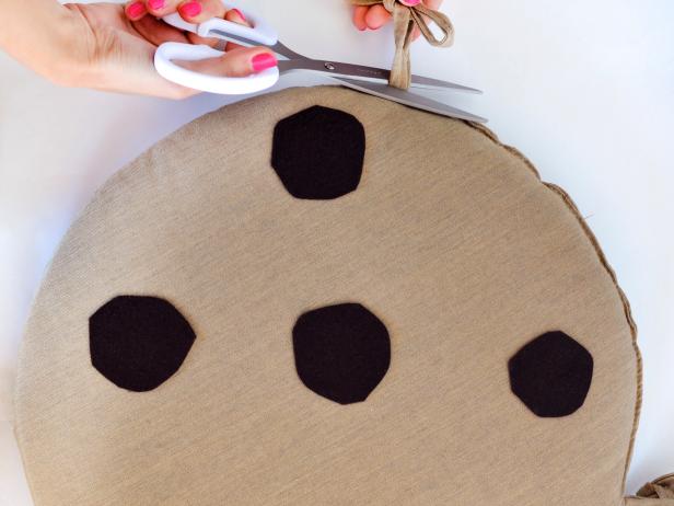 Remove attached chair ties then use safety pins to attach two ribbons to the bare side of both chair cushions.