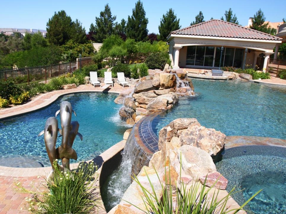Multi-Level Pool Area with Stone Accents and Water Feature