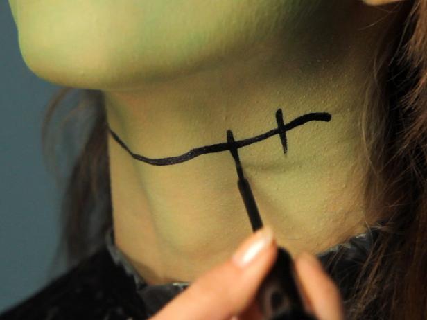 To turn your tween into a hip Frankenstein for Halloween, cover the entire face with green cream makeup. Define brows with a makeup pencil, and cover lids in mauve eyeshadow. Add liner and mascara for older girls. On one cheek, draw a short line with black liner under eye, angling down toward the jawbone. Shade under line with a touch of mauve or purple eyeshadow to make it appear three-dimensional. Next, use black liner to draw vertical stitch lines or, for a super-easy way to make the detail appear more realistic, glue little pieces of black yarn across the drawn line using eyelash glue. Continue stitch effect across the neck using black liner. Shade around stitch effect on neck with a touch of mauve or purple eye shadow to make it appear three-dimensional. Line lips and fill in with red liner. Using a rich red lipstick, coat lips.