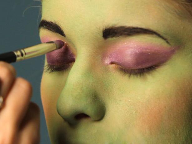 To turn your tween into a hip Frankenstein for Halloween, begin with a green cream makeup base. Cover entire face using a sponge. Using a fluffy blending brush and a light green eye shadow, cover the face everywhere the green cream makeup was applied. Add a touch of pink blush to apples of cheeks. Define eyebrows with brown or gray eyebrow pencil. Cover eyelids with a purple or mauve eyeshadow and blend up to crease. Use a slightly lighter shade at the halfway point and blend the colors together. For older girls who are comfortable wearing eye makeup, add black liner and mascara to top and bottom lashes to define them and make the eyes appear larger. Add stitch lines and bolts.