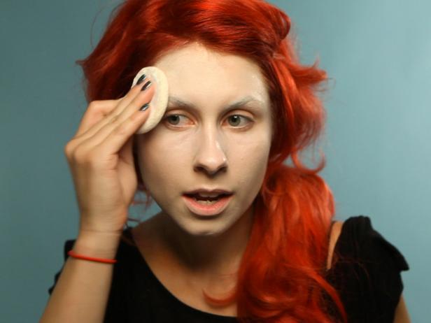Set foundation with white face powder. Apply with a fluffy powder puff and blend out excess using a powder brush.
