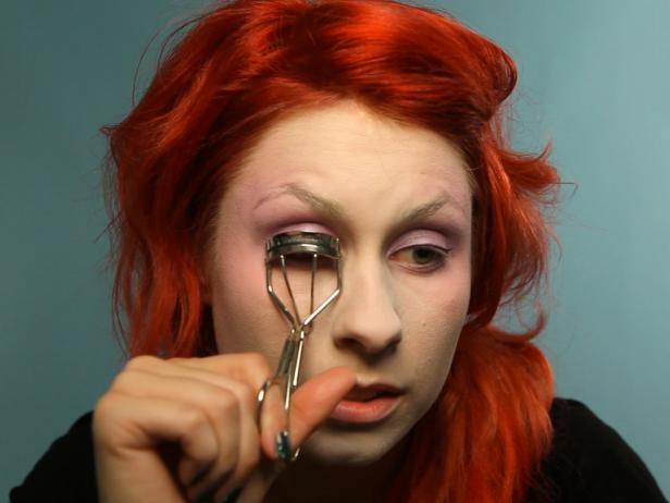 Curl lashes, then coat them with black mascara on top and bottom.