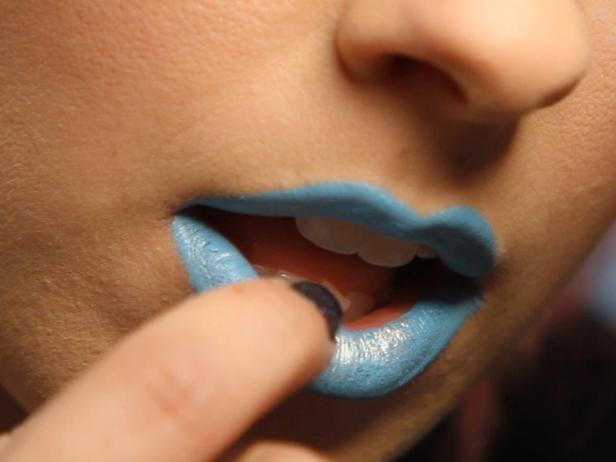 Blot a dab of silver/white mineral eye shadow in the center of your lips for shimmer.