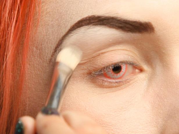 Go over the white liner with white shadow to define brows and act as a base for blending.
