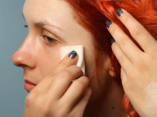 Prime skin using a foundation primer. Mix foundation in a shade close to your skin tone with white foundation then apply mixture over face, ears and neck with a makeup sponge.
